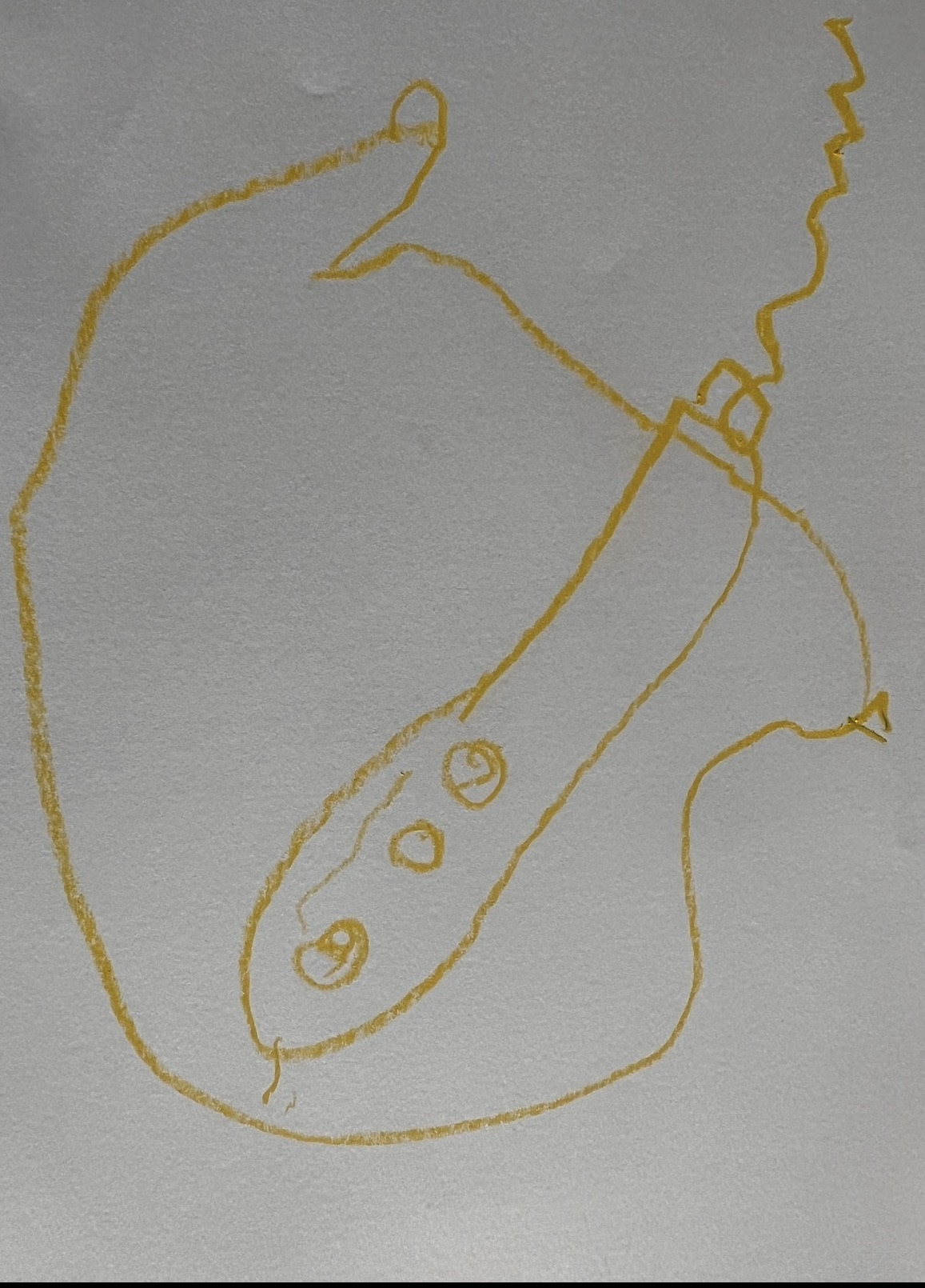 Yellow crayon drawing of a vehicle or submarine with windows and details showing imaginative storytelling in child art