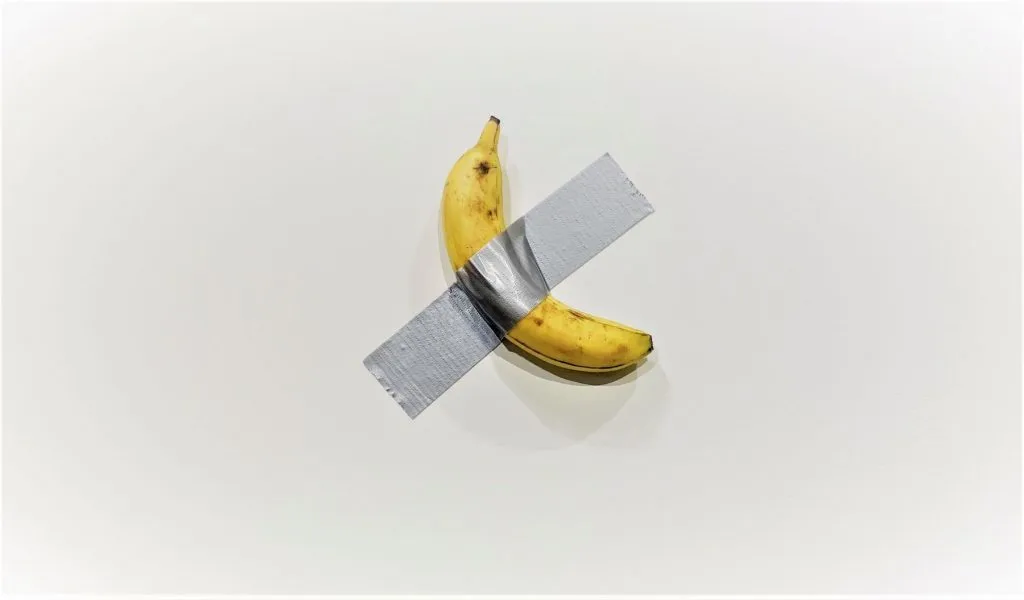 Comedian by Maurizio Cattelan - a banana duct-taped to a white gallery wall, sold for $120,000 at Art Basel Miami